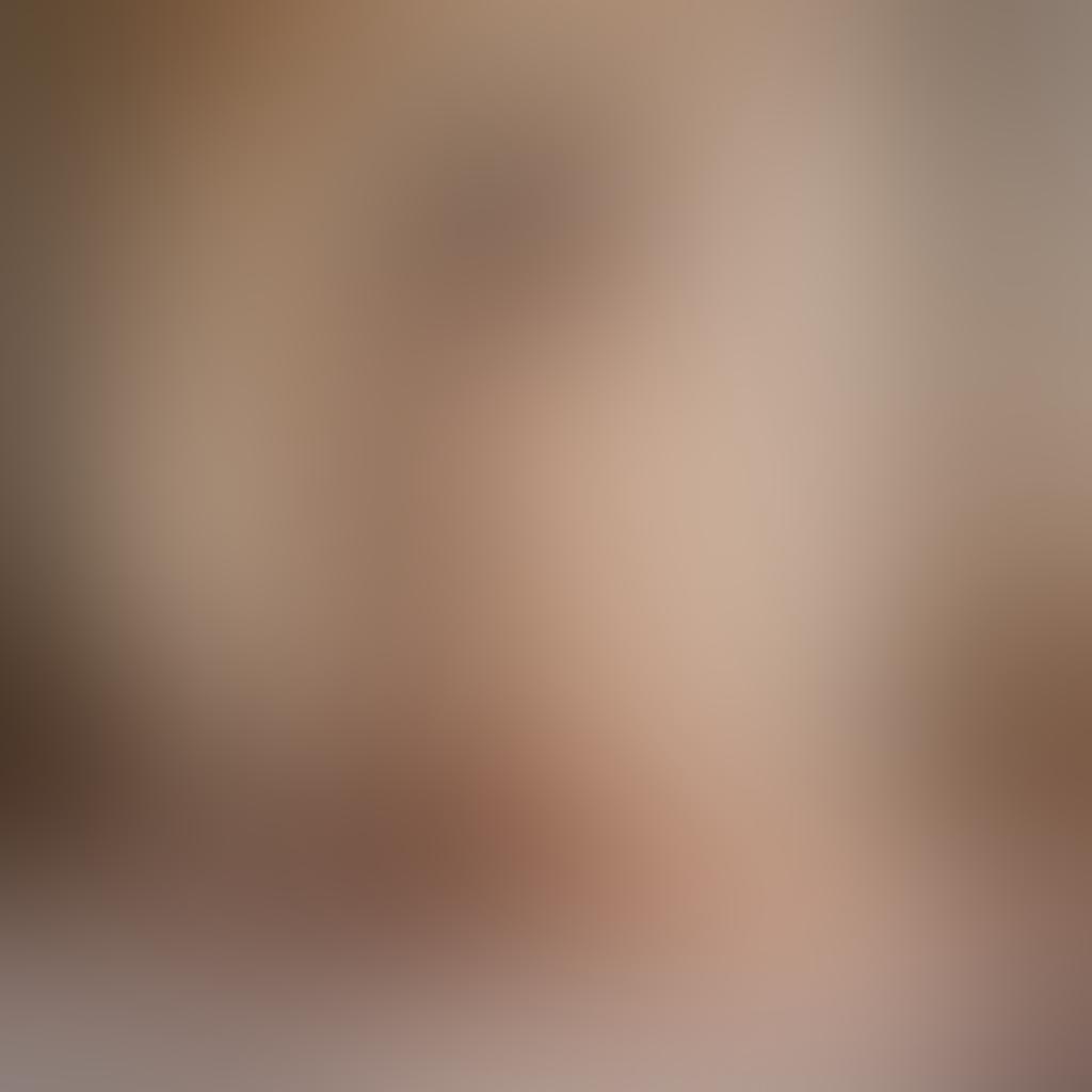 A captivating scene showcasing the elegance of nude photography, featuring an artist's studio filled with soft, natural light. The focal point is a beautifully posed nude model, embodying grace and intimacy, surrounded by art supplies and stunning photographs. Ethereal shadows play across the walls, creating a warm, inviting atmosphere that enhances the theme of passion and sensuality. delicate drapery softly framing the model evokes a sense of intimacy. super-realistic. soft pastels. intimate atmosphere.